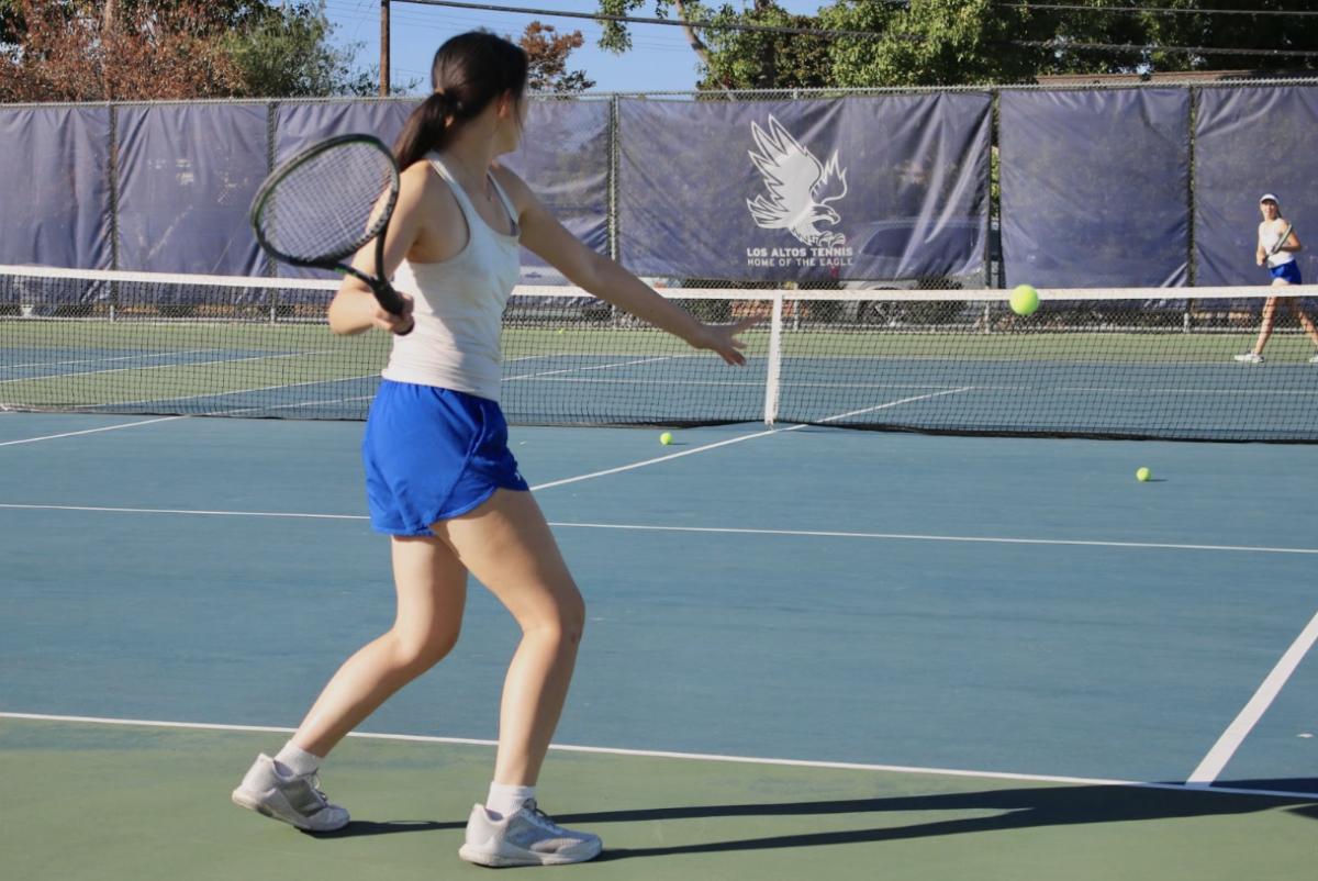 Captain Carissa Lai warms up while waiting for her rematch against the Vikings where she and her partner, senior Ayana Modi won both sets 6–2 and 6–3, contributing to the Eagles’ 7–0 victory. 